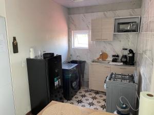 a small kitchen with a refrigerator and a stove at Hermoso apartamento en Cerro Viento in Juan Díaz