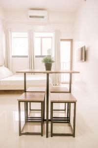 a table with two chairs and a table with a plant on it at Urban Nest with a View in Iloilo City