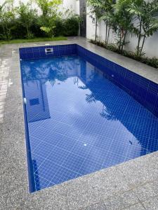 a swimming pool with blue tiles on the ground at Luxury 2 bedrooms Labone Loft suites in Accra