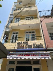a building with a sign on the side of it at Nhà Nghỉ Hoa Cúc Xanh Lừa Đảo in Hue