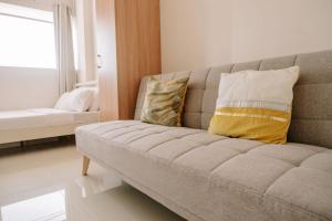 a living room with a couch with pillows on it at A Simple Cozy Retreat in Iloilo City