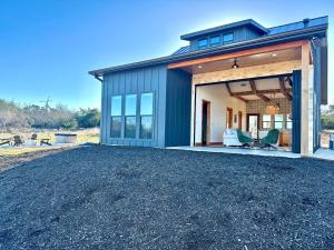 a house with a large garage and a driveway at Sunday House at The Sanctuary in Fredericksburg