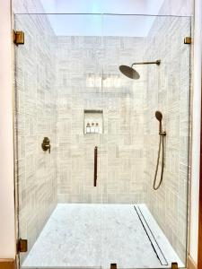 a bathroom with a shower with a glass door at Sunday House at The Sanctuary in Fredericksburg +19 photos