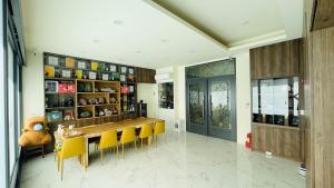 a dining room with a table and yellow chairs at Hualien Leo and Alley Elevator B&B in Hualien City