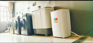 a row of washers and dryers in a laundry room at 天门山云尚景豪酒店 in Zhangjiajie