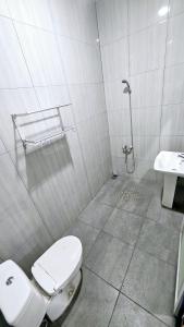 a bathroom with a toilet and a sink at New Tiga Intan Hotel in Bandung +17 photos