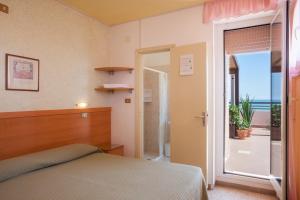 Postel nebo postele na pokoji v ubytování Hotel Cristina