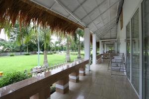 a porch of a resort with chairs and tables at Rangauti Resort in Binesri