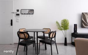 a table and chairs in a room at neve tzedek luxury family apartment by rently in Eilat +1 photo