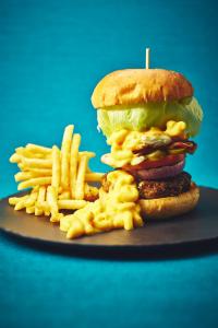 a hamburger and french fries on a plate at ANA InterContinental Manza Beach Resort by IHG in Onna