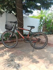 a bike is parked next to a tree at Sun n Tan Beach Home stay in Kannur