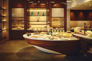 a large room with a wooden boat in it at ANA InterContinental Manza Beach Resort by IHG in Onna