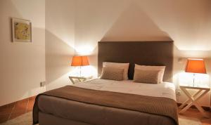 a bedroom with a large bed with two lamps at Praia Del Rey ByThe Pools in Casal da Lagoa Seca +19 photos