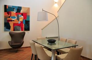 a dining room with a glass table and chairs at Praia Del Rey ByThe Pools in Casal da Lagoa Seca