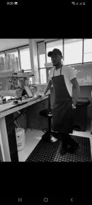 a man standing in a kitchen preparing food at Riyadh Barista Training School Nansana Uganda in Kampala +28 photos
