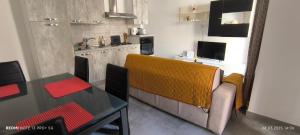 a kitchen with a couch and a table in a room at One bedroom TEA apartment Il-Gzira in Il-Gżira