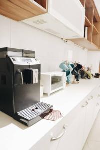 a kitchen with a coffee maker on a counter at Day and Day Hotel No1 in Tianwei