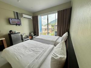 Postel nebo postele na pokoji v ubytování Siri Hotel Phuket