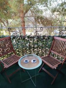 two chairs and a table on a balcony at Verona Bed and Relax Apartment in Verona