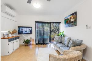 a living room with a couch and a tv at Pearl of Scarborough in Scarborough