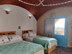 Postel nebo postele na pokoji v ubytování Nubian Hights guesthouse + 5 fotografií