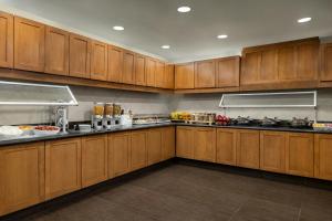 a large kitchen with wooden cabinets in a kitchen at Residence Inn by Marriott Richmond Chester in Woodvale