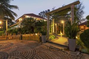 a house with a pavilion in front of a brick driveway at Ananta Vilas by StayJadeLuxuriousPrivate Pool in Kumbalgod