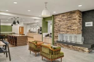 a lobby with chairs and a brick wall at Fairfield Inn & Suites Mt. Pleasant in Mount Pleasant
