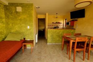 a living room with a couch and a dining room at Latitud 49 Apart in El Chalten