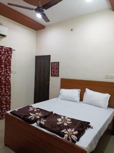a bedroom with a large bed with white sheets at Hotel saanvi inn in Raipur +6 photos