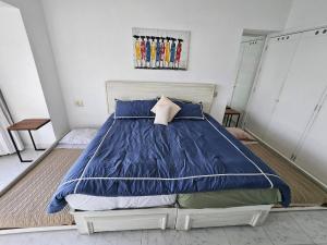 a bedroom with a large bed with blue sheets at Tropical Paradise Getaway in Acapulco with Private Infinity Pool in Acapulco