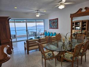 a living room with a table and chairs and a couch at Tropical Paradise Getaway in Acapulco with Private Infinity Pool in Acapulco