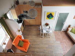 an overhead view of a living room and kitchen with an orange chair at Wohnen überm Atelier in Bad Neuenahr-Ahrweiler
