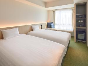 Dorsett by Agora Osaka Sakai客房内的一张或多张床位