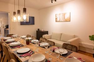 a dining room with a table and a couch at Munich large Apartment 110 qm in very cetral location 1 to 12 Guests in Munich