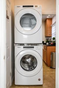 two washing machines stacked on top of each other in a kitchen at Comfortable Home Near LA with Full Kitchen & Laundry in Alhambra
