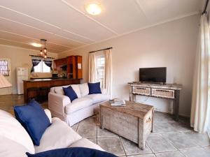 a living room with two couches and a tv at Wildecrest & Ripplemead, Amblewood Guesthouse in Kenton on Sea