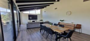 a dining room with a table and chairs and a couch at The Shack in Walker Flat