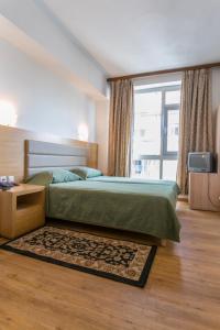 雅典Arethusa Hotel Athens的一间带床和大窗户的卧室 更多37张照片