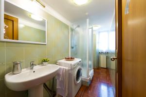 a bathroom with a sink and a washing machine at Holiday Home House Fornaci in Rome +25 photos