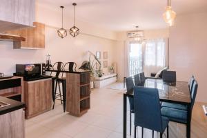 a kitchen and living room with a table and chairs at Spacious Comfort for Groups in Iloilo City
