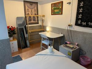 バーン・タイにあるBeach Bungalow Retreatのベッド、テーブル、テーブルが備わる客室です。