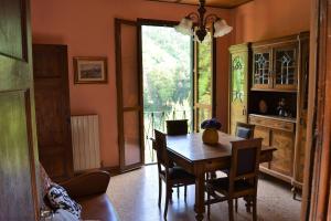 a dining room with a wooden table and chairs at Bellavista apartment in Bagni di Lucca