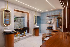 a bathroom with a sink and a mirror at Lalasa Villas Canggu in Canggu