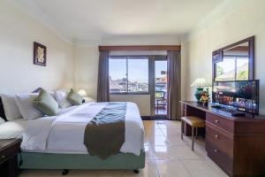 a bedroom with a large bed and a television in it at Private Apartment 6503 at the Jayakarta Residence in Seminyak +19 photos