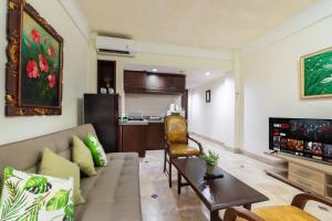 a living room with a couch and a table at Private Apartment 6503 at the Jayakarta Residence in Seminyak