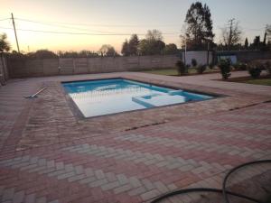 a swimming pool in the middle of a backyard at Self catering apartment in Vereeniging