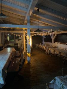 a restaurant with tables and benches in a room at Pokoje Maria in Międzybrodzie Bialskie
