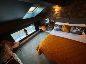 a bedroom with an orange bed and two windows at Aiskew Villa Annex in Bedale