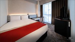 Postel nebo postele na pokoji v ubytování DEL style Ikebukuro Higashiguchi by Daiwa Roynet Hotel